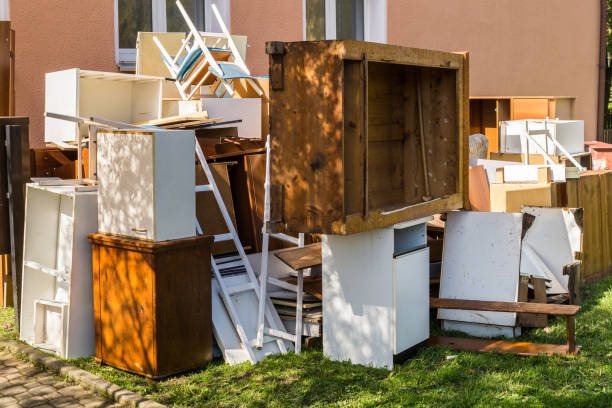Pile of household furniture, timber and whitegoods stacked kerbside for rubbish removal